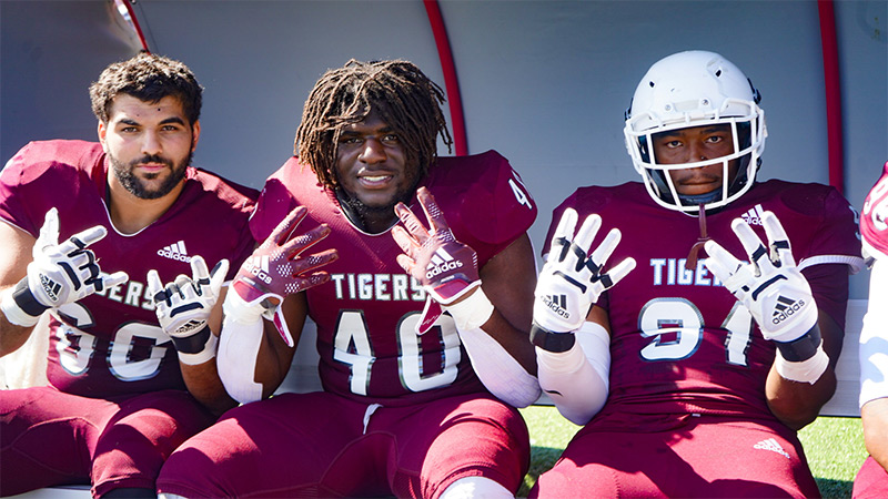 Photo of three football players Photo of three football players